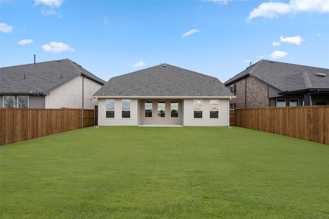 rear view of house with a lawn