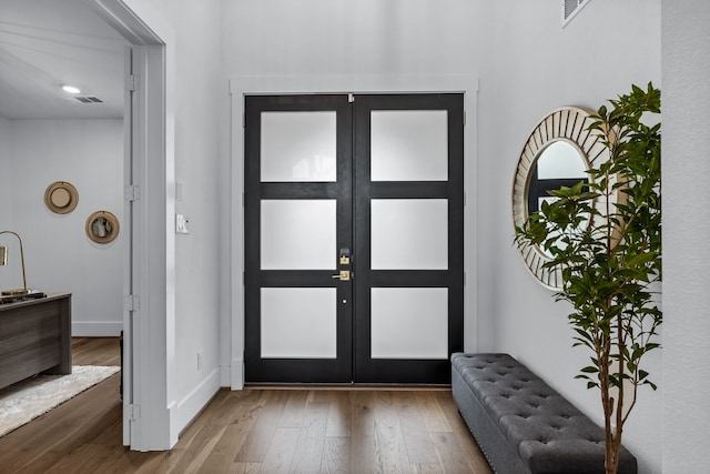 foyer entrance featuring wood-type flooring and french doors