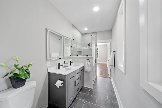 bathroom with walk in shower, vanity, toilet, and tile patterned flooring