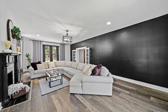 living room with hardwood / wood-style flooring and a notable chandelier