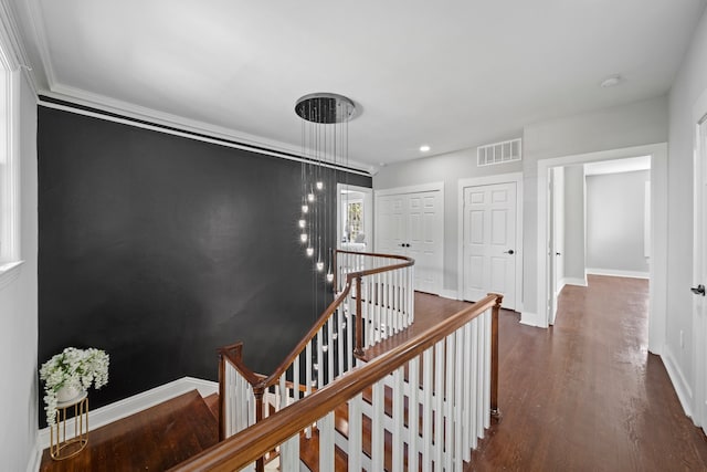 hall with crown molding and dark wood-type flooring