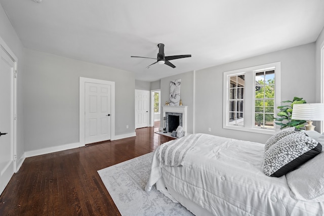 bedroom with dark hardwood / wood-style floors and ceiling fan