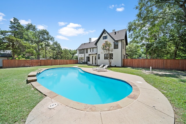 view of swimming pool featuring a patio area and a lawn