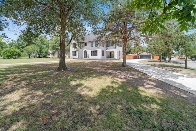 colonial house with a garage and a front yard