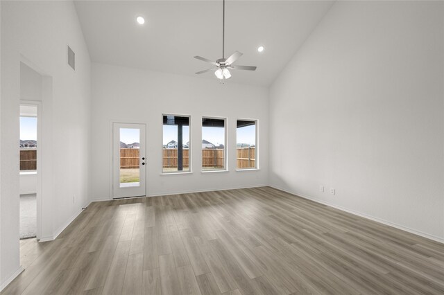 dining area with light hardwood / wood-style floors, a wealth of natural light, ceiling fan, and high vaulted ceiling