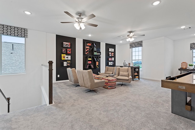 carpeted living room with ceiling fan