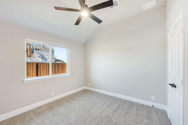 carpeted spare room with ceiling fan and lofted ceiling