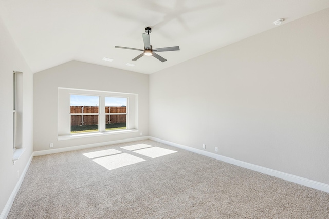 carpeted spare room featuring ceiling fan and lofted ceiling