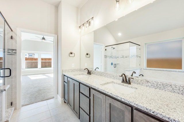 bathroom with ceiling fan, walk in shower, tile patterned flooring, lofted ceiling, and vanity