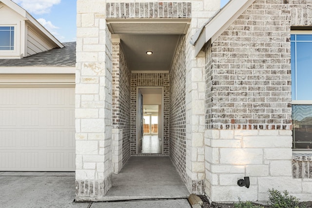 doorway to property with a garage