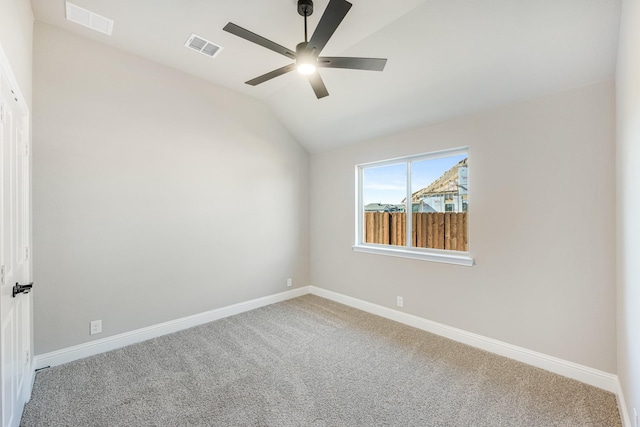 spare room featuring ceiling fan, carpet, and vaulted ceiling