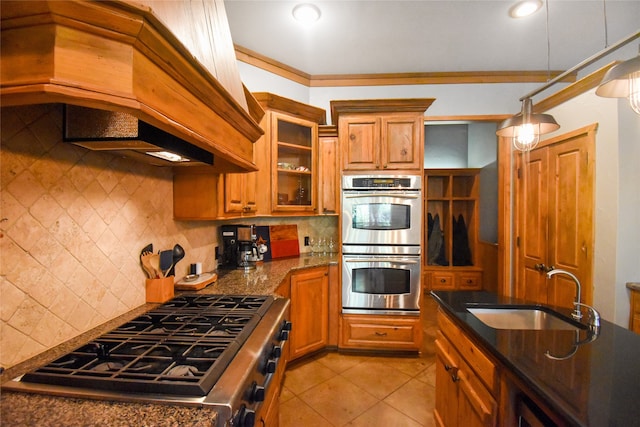 kitchen with appliances with stainless steel finishes, tasteful backsplash, ornamental molding, sink, and custom exhaust hood