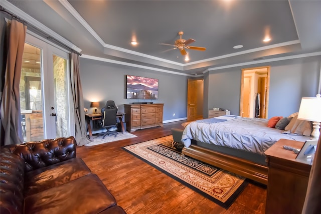 bedroom with ornamental molding, access to outside, wood-type flooring, ceiling fan, and a tray ceiling