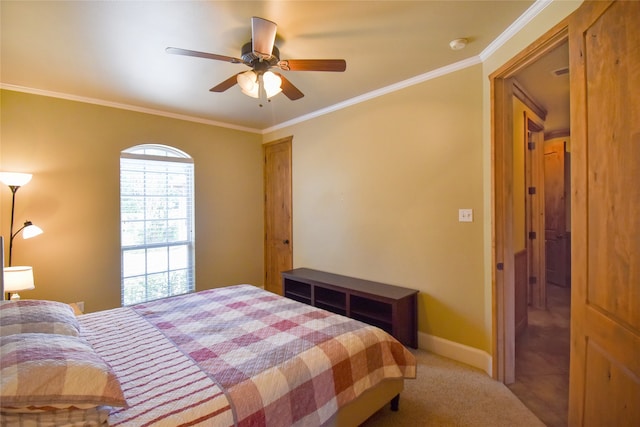 carpeted bedroom with ceiling fan and crown molding