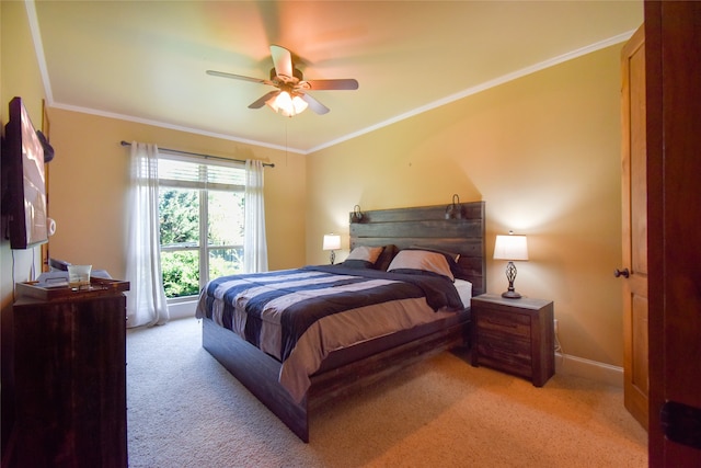 carpeted bedroom with ceiling fan and ornamental molding