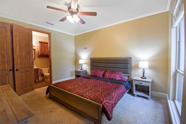 bedroom with ornamental molding, connected bathroom, ceiling fan, and carpet