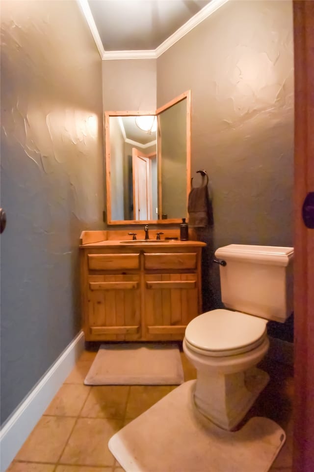 bathroom with tile patterned flooring, vanity, toilet, and ornamental molding