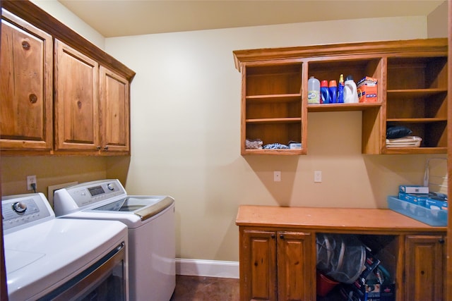 laundry room featuring cabinets and washing machine and clothes dryer