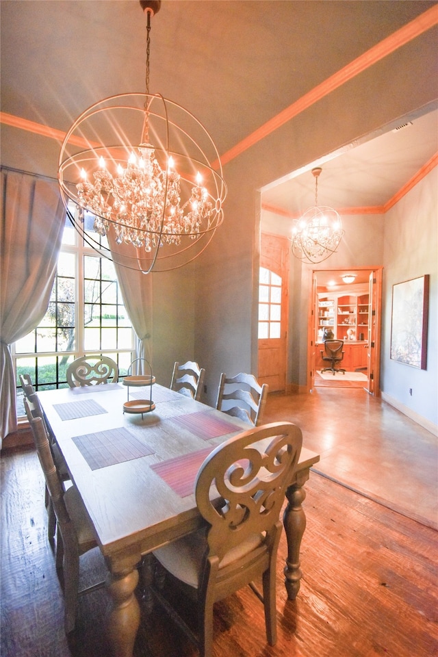 dining room featuring ornamental molding, built in shelves, hardwood / wood-style flooring, and an inviting chandelier