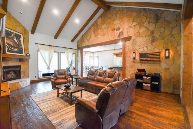 living room featuring dark wood-type flooring, beamed ceiling, a stone fireplace, and high vaulted ceiling