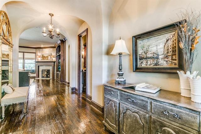 hallway featuring dark wood-type flooring and a chandelier