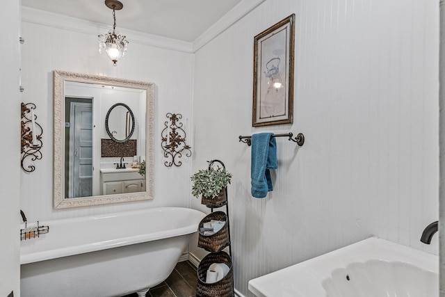 bathroom featuring a bath, crown molding, a chandelier, and vanity