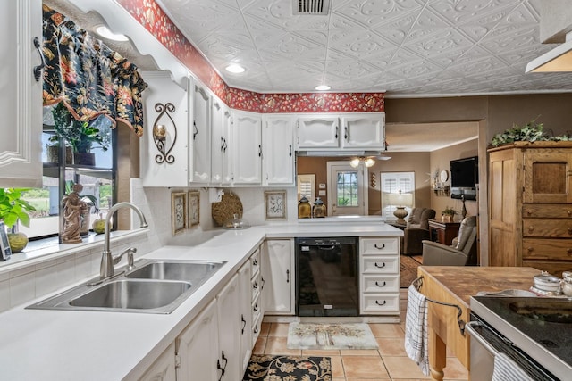 kitchen with a wealth of natural light, black dishwasher, white cabinetry, and sink