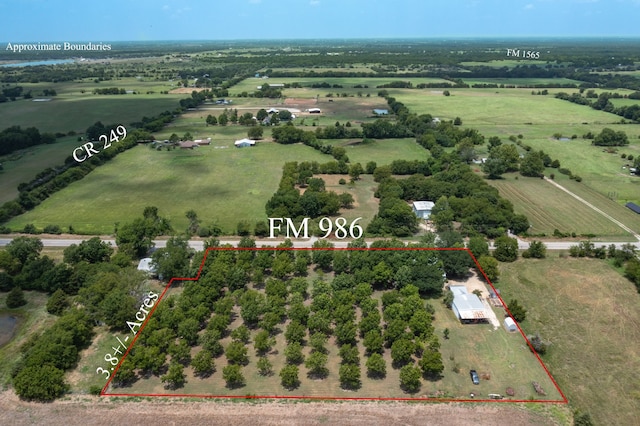 birds eye view of property with a rural view