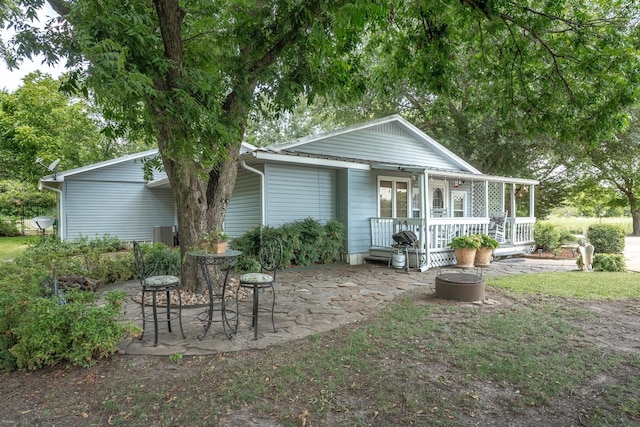 back of property featuring covered porch and a patio area