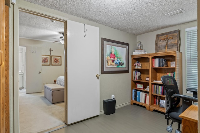 office with ceiling fan and a textured ceiling