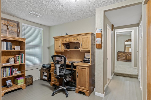 office featuring a textured ceiling and light wood-type flooring