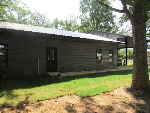 rear view of house featuring a lawn