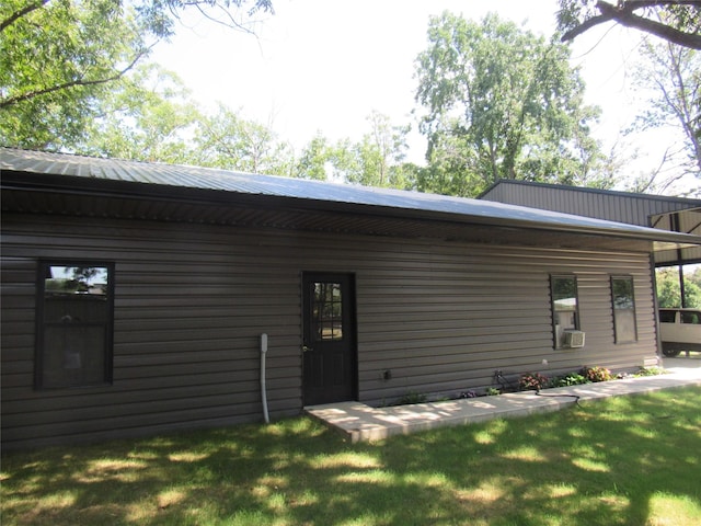 rear view of property featuring a lawn