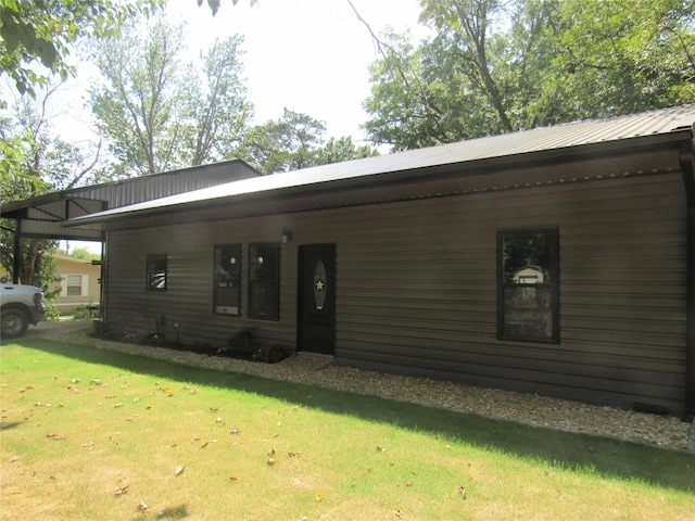 ranch-style house with a carport and a front lawn