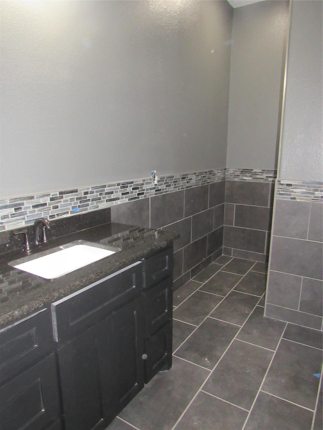 bathroom featuring tile patterned floors, vanity, and tile walls