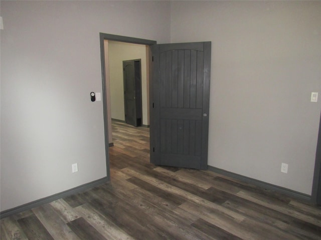 empty room with dark hardwood / wood-style floors