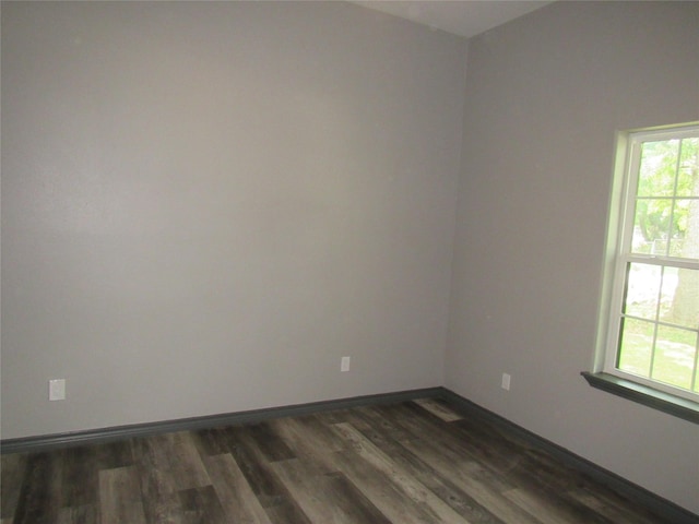 unfurnished room featuring dark wood-type flooring