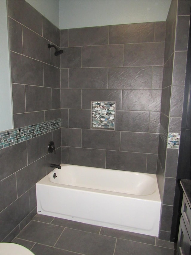 full bathroom featuring tile patterned flooring, vanity, toilet, and tiled shower / bath