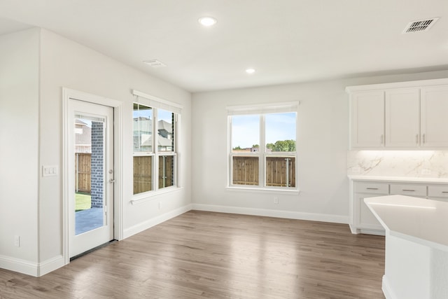 unfurnished dining area with wood-type flooring