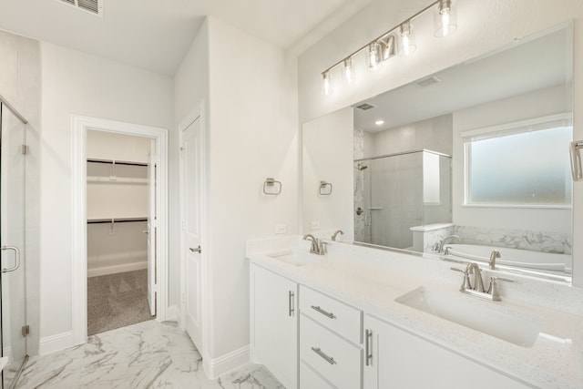 bathroom with vanity and independent shower and bath