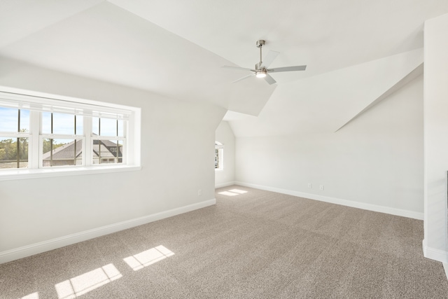 additional living space featuring lofted ceiling, carpet, and ceiling fan