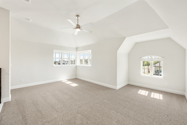 unfurnished living room with vaulted ceiling, carpet flooring, and ceiling fan