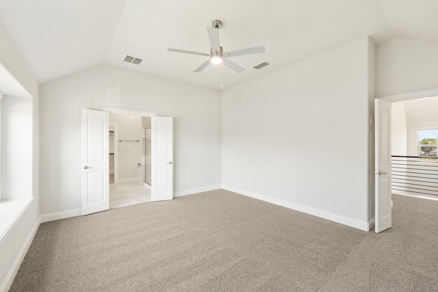 unfurnished room featuring lofted ceiling, light carpet, and ceiling fan