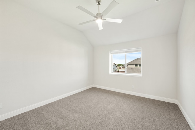 empty room with vaulted ceiling, carpet flooring, and ceiling fan