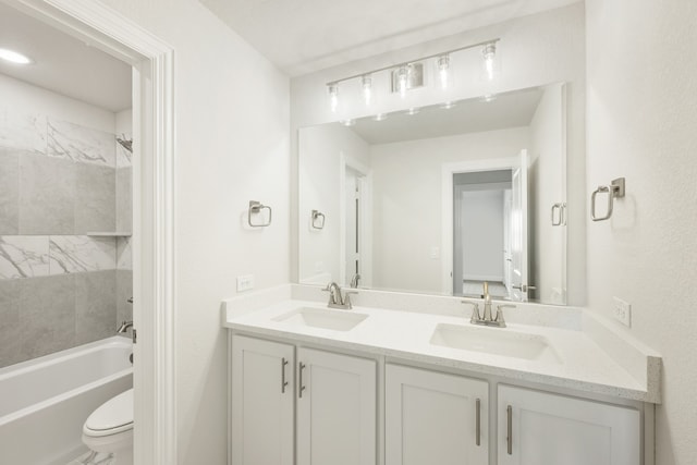 full bathroom with vanity, toilet, and tiled shower / bath combo