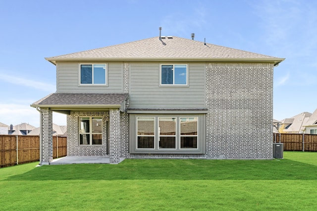 back of property with a yard and a patio area