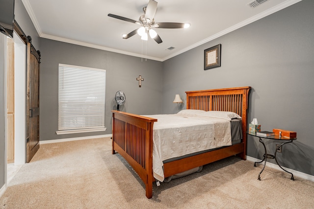 carpeted bedroom featuring ornamental molding, a barn door, and ceiling fan