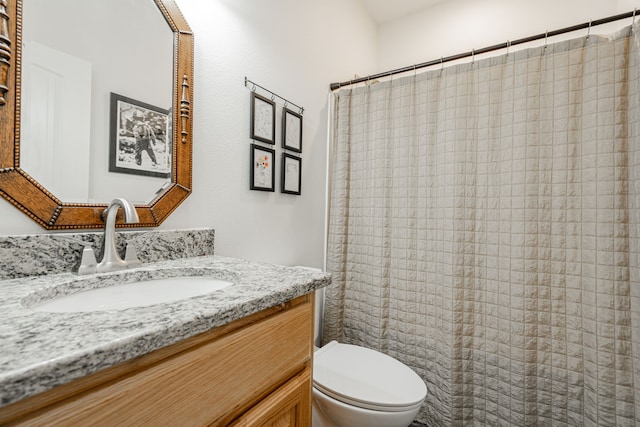 bathroom with vanity, toilet, and walk in shower