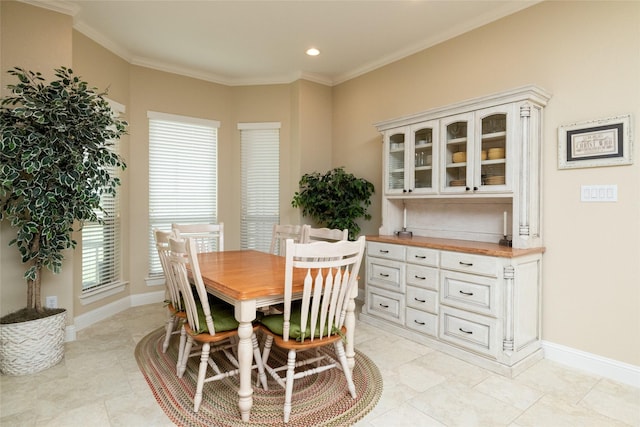 dining area featuring ornamental molding and baseboards