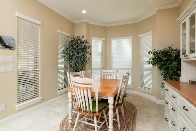 dining space featuring ornamental molding, recessed lighting, and baseboards